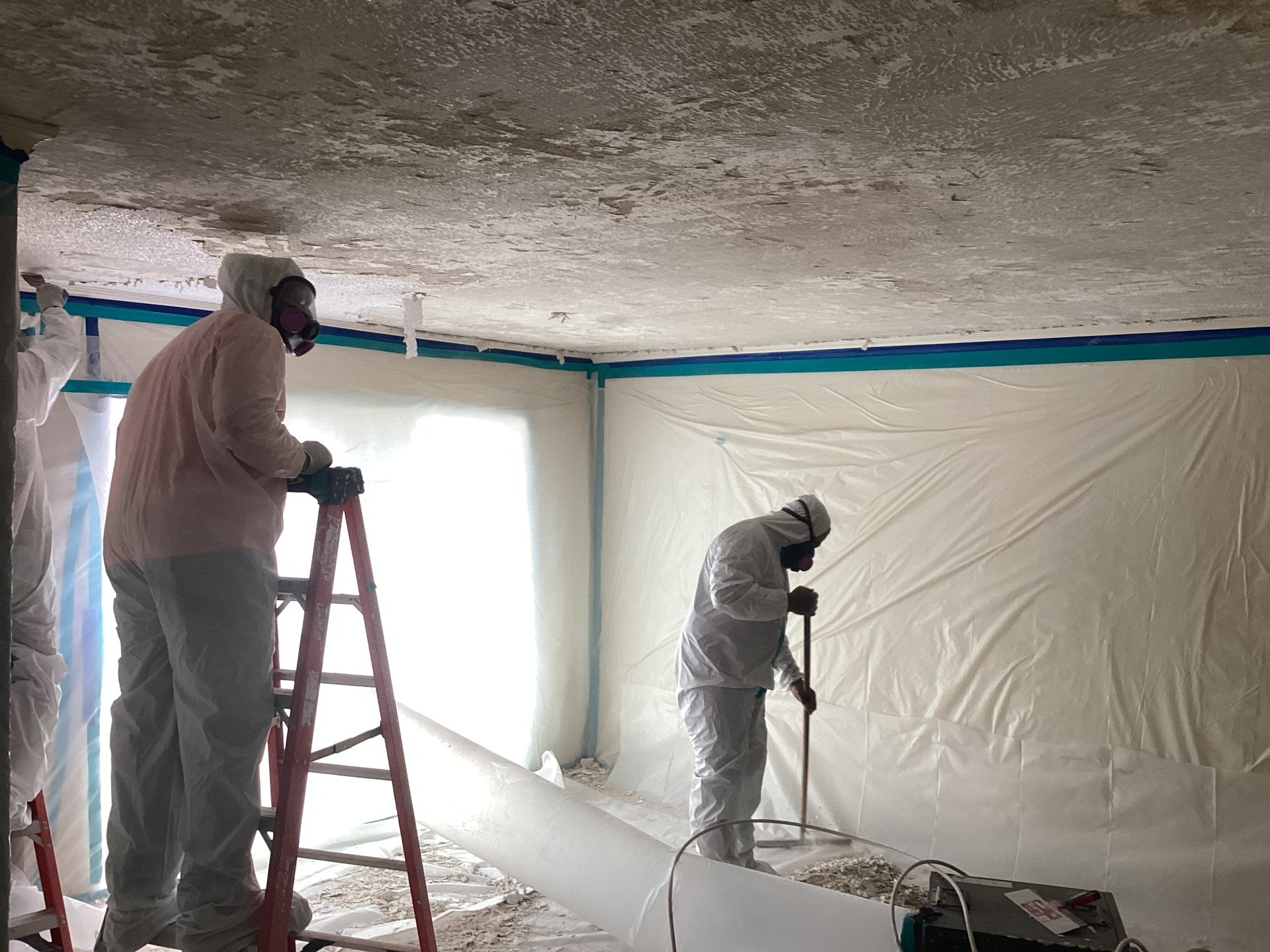 Coastal Risk Management technicians performing asbestos abatement work