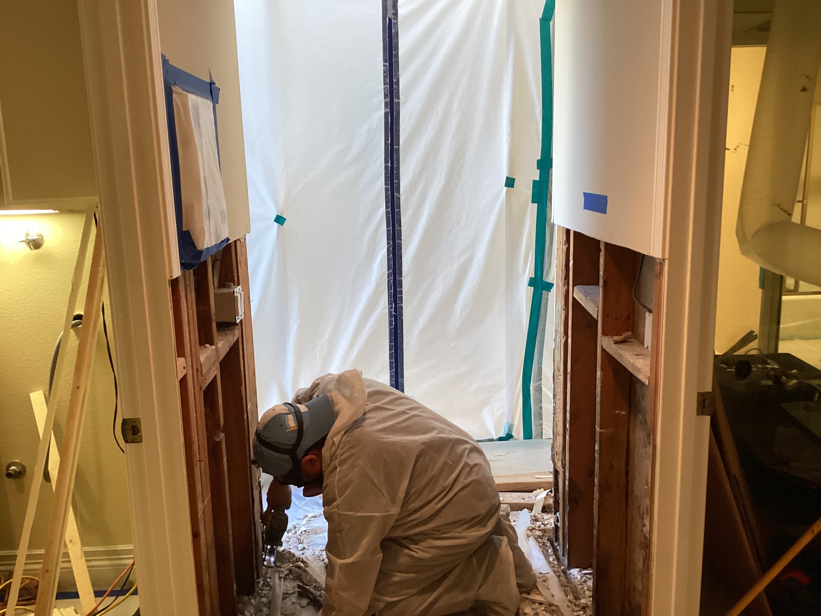Environmental remediation professional inspecting an interior work area
