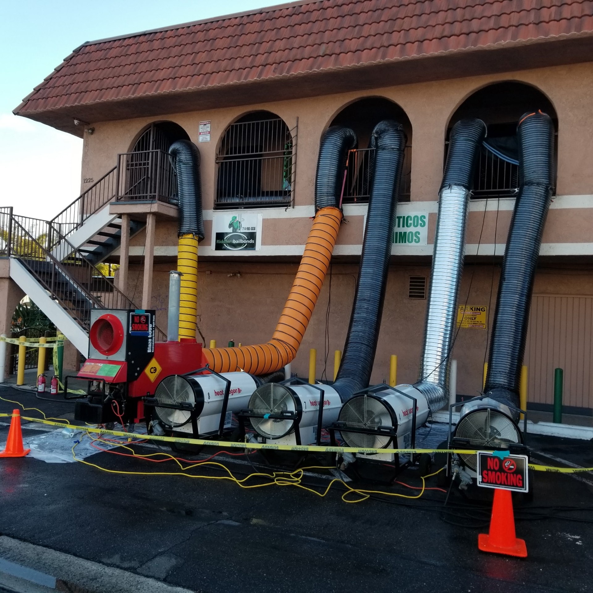 Heat drying equipment with industrial ducting set up outside a commercial building